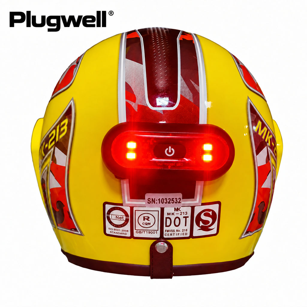 Plugwell USB Rechargeable Motorcycle and Bicycle Helmet Taillight glowing bright red mounted on a yellow helmet.