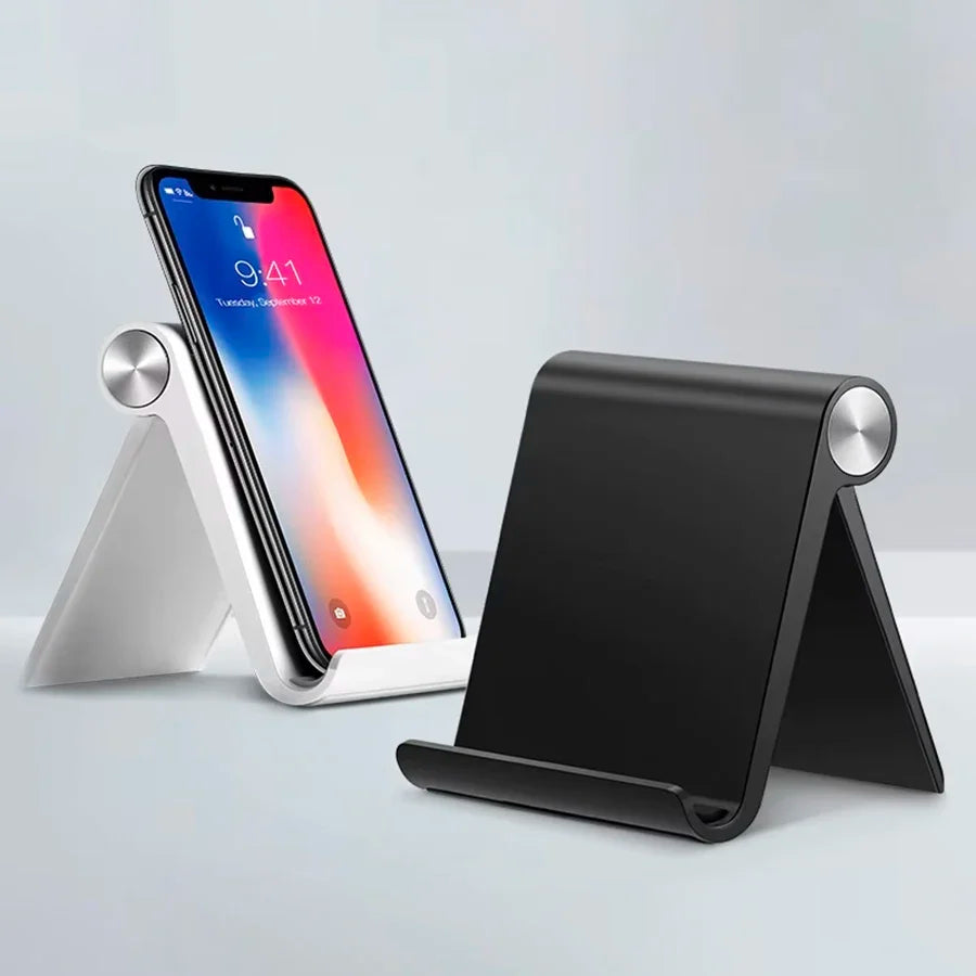 Plugwell Adjustable and Foldable Desktop Phone Stand holding a smartphone next to a black folding stand on a modern desk.